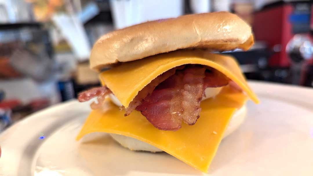 egg, ham, and cheese on a bagel