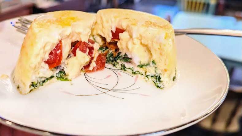 Egg bite filled with tomatoes, spinach, and feta