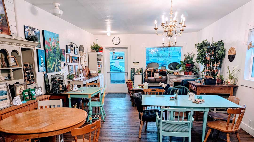 two tables and with chairs in a cozy white cafe