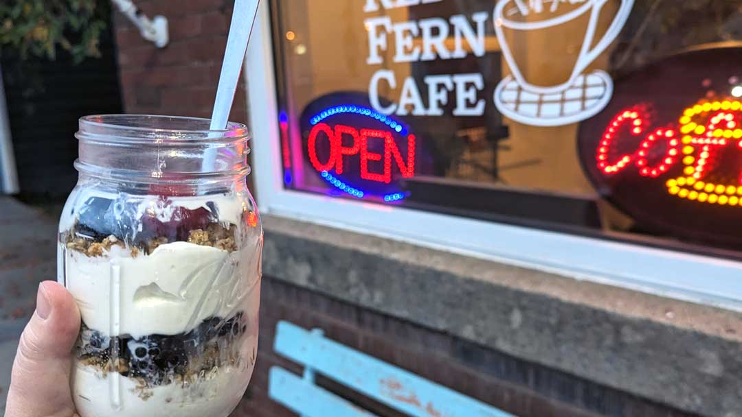 layers of yogurt, berries, and granola in a mason jar